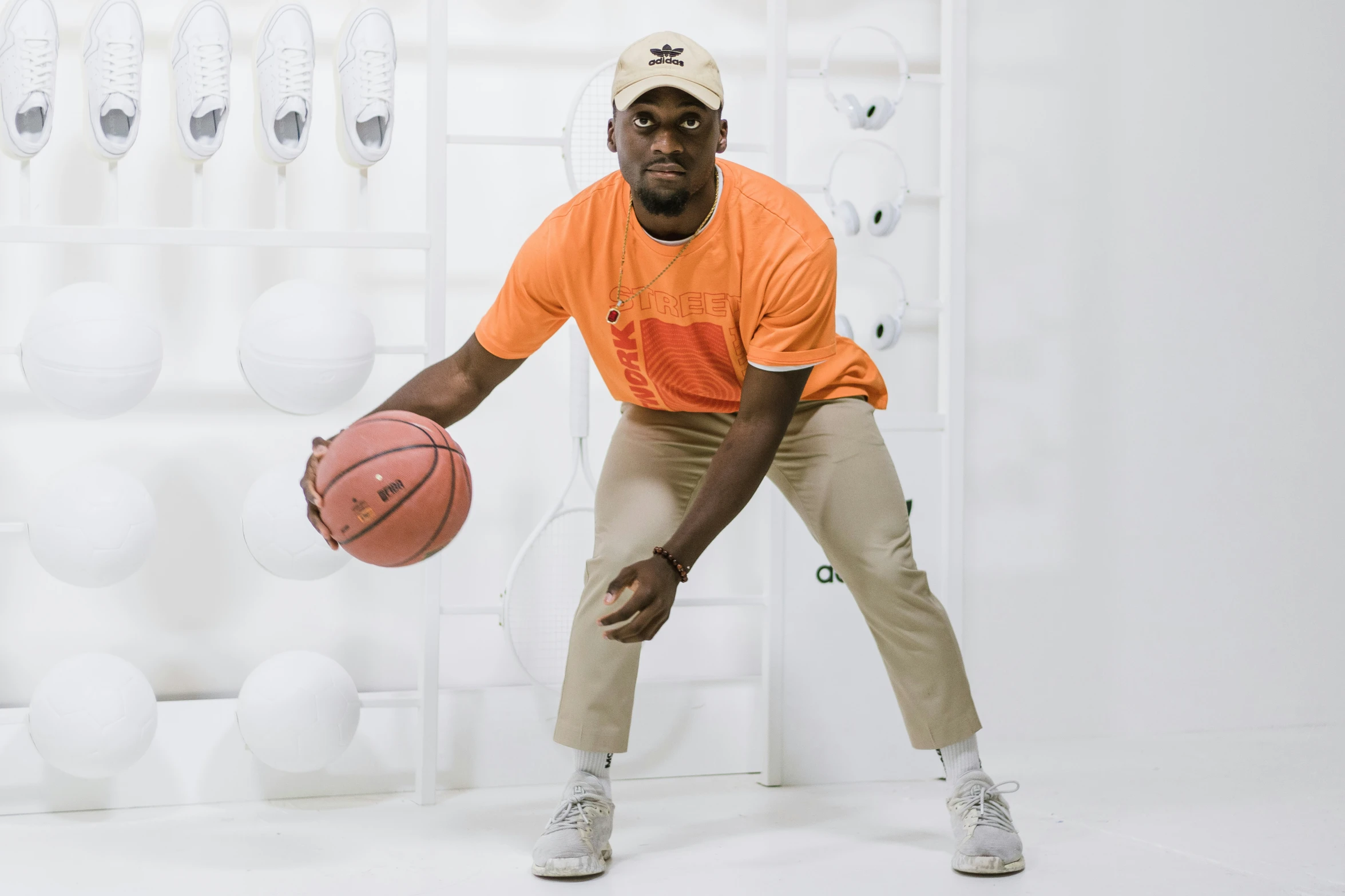 a man holding a basketball standing in front of shelves