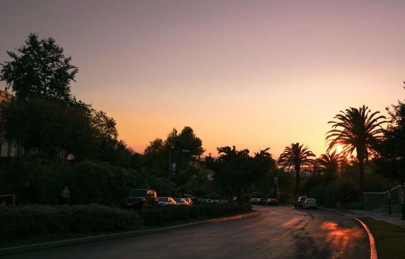 a sunset view of a street at an intersection