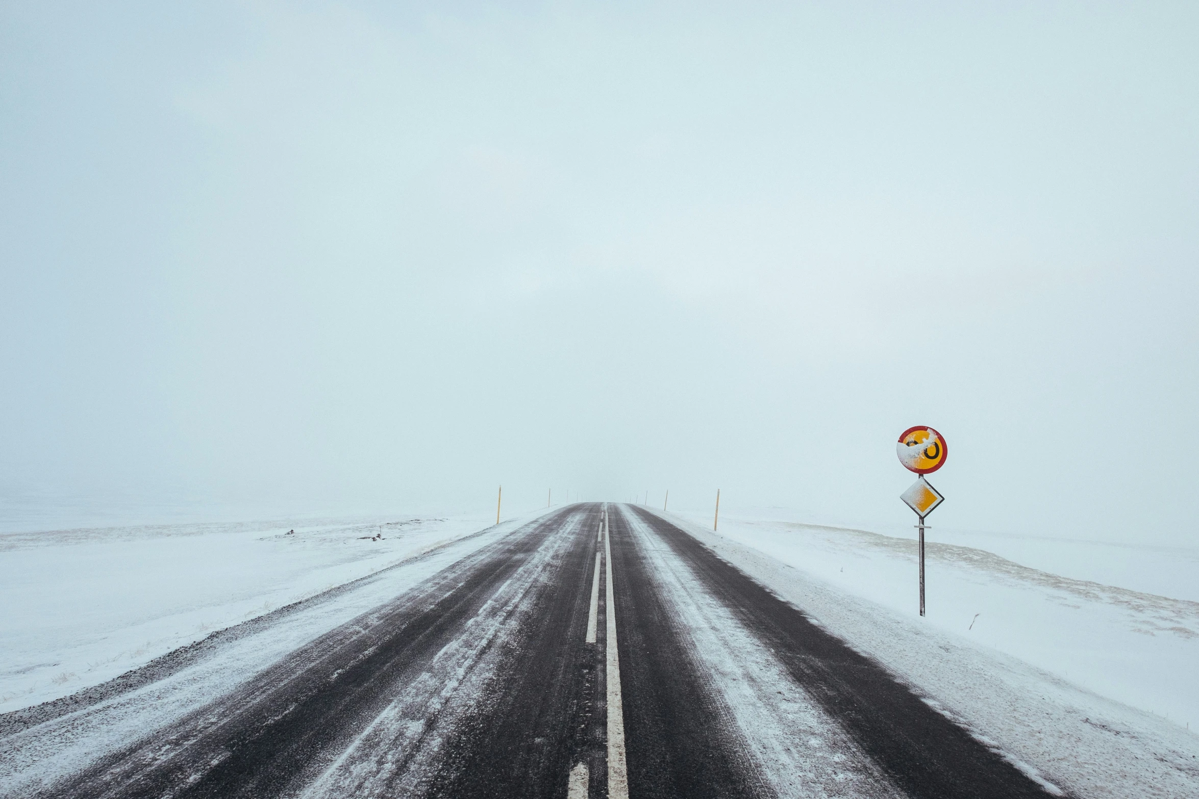 a road that has some snow on the side of it