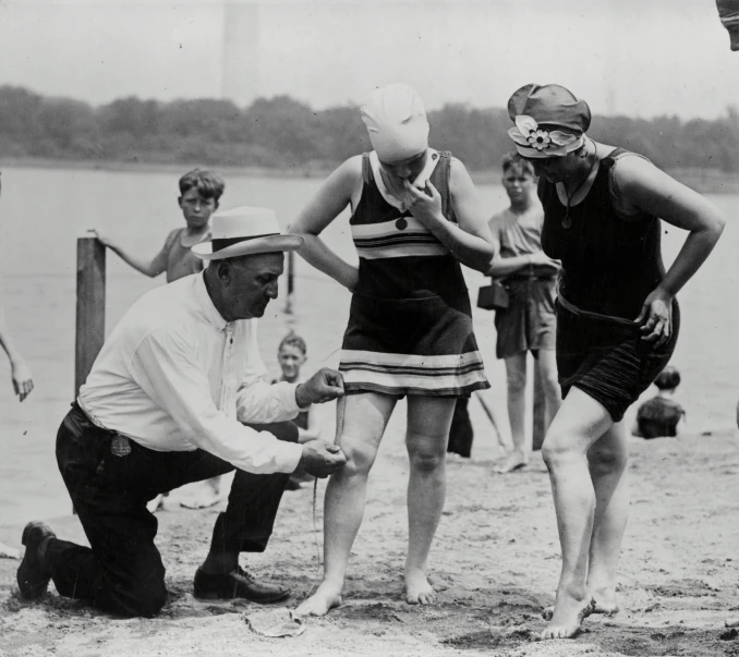 a group of people standing around each other next to a water