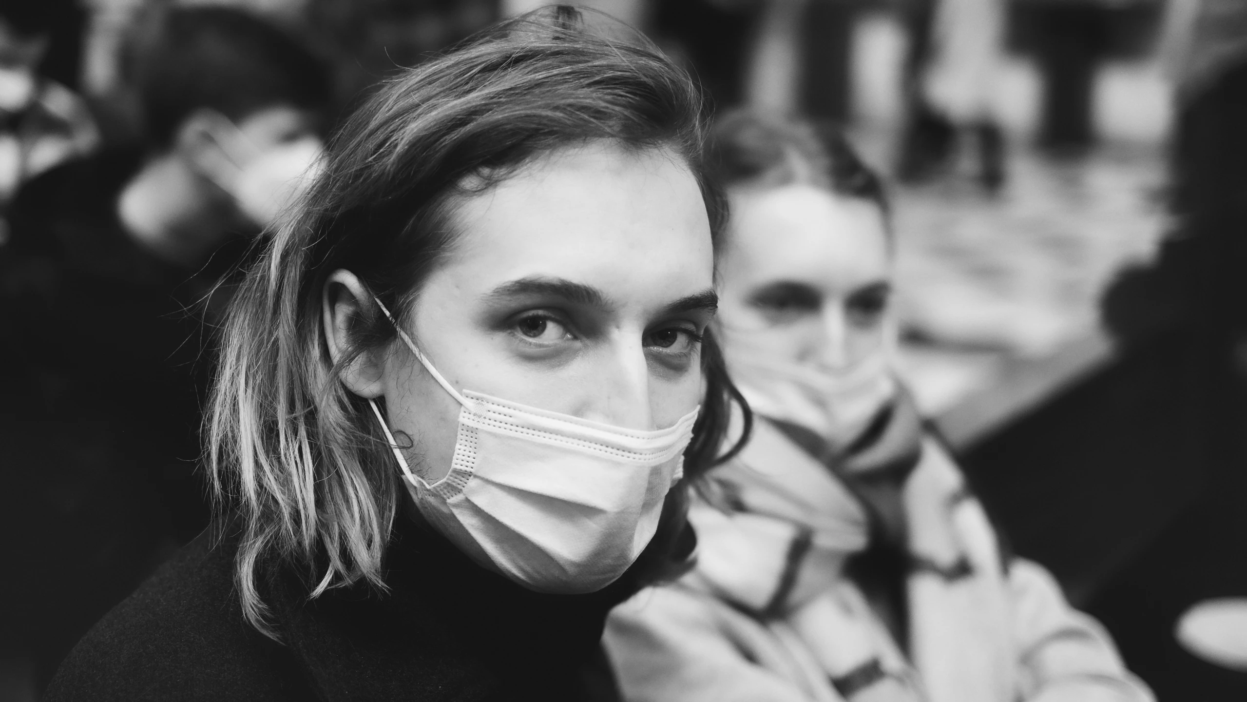 a black and white po shows two people wearing masks