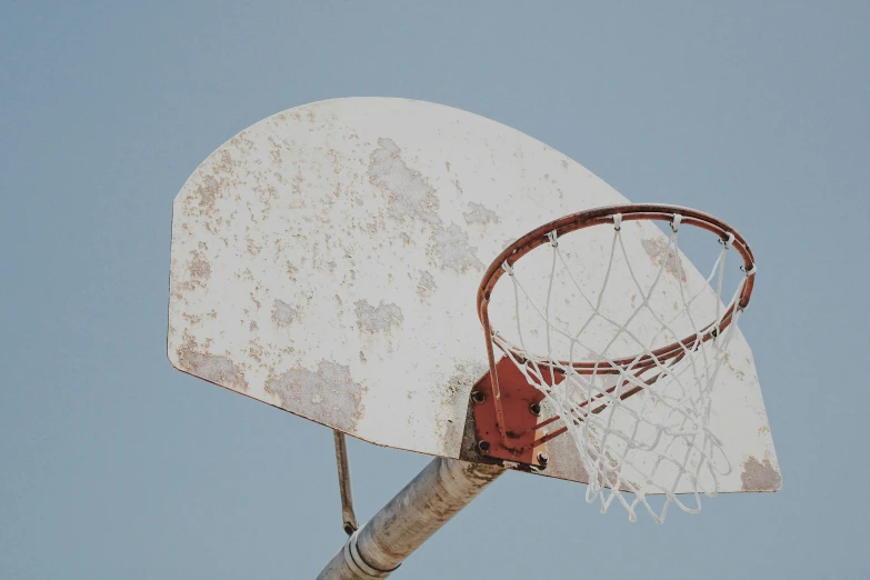 the rim of a basketball hoop with a rusted piece of material