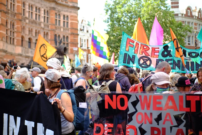 a crowd of people that are marching with a sign