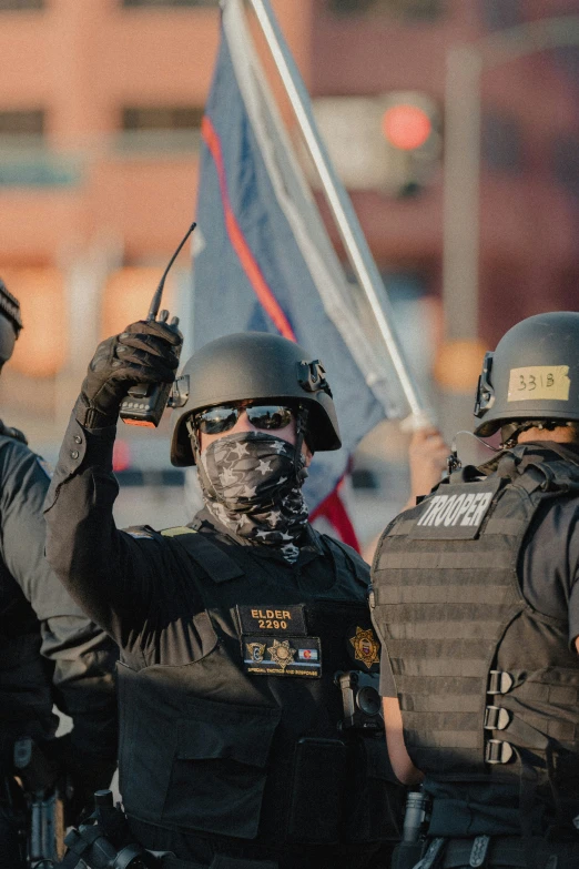 a couple of people in police uniforms and holding flags