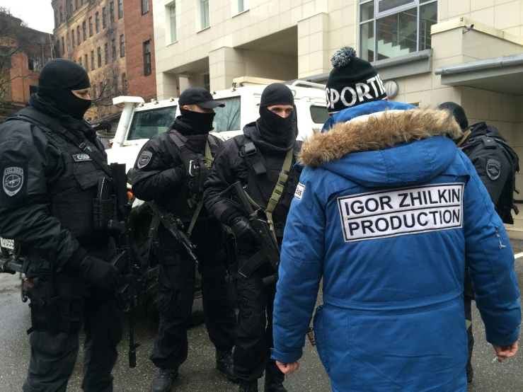 a group of police officers stand together on the street