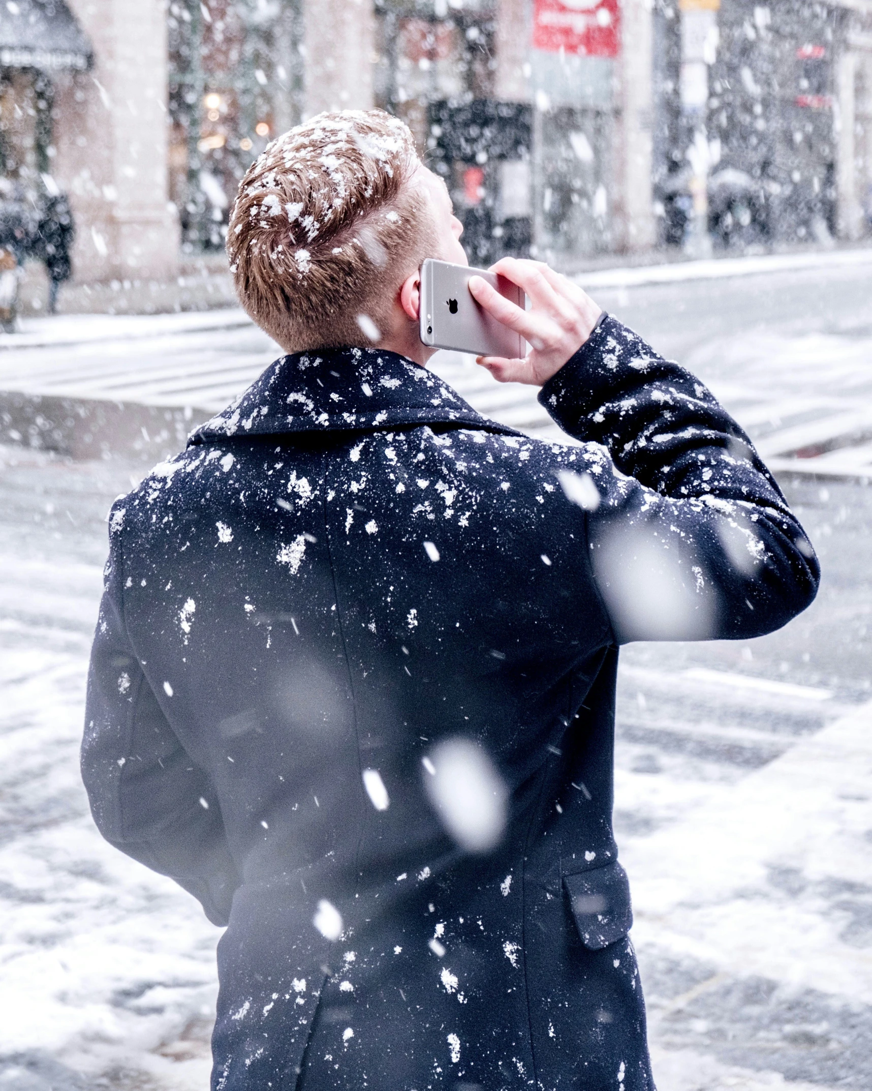 a man on the phone on a snowy day