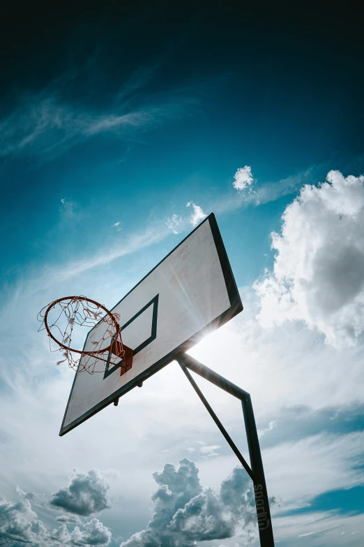 a basketball court that has a sky in the background