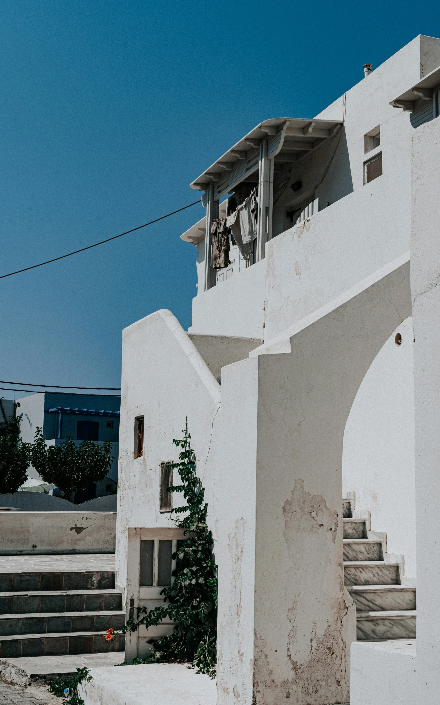 the white building with balcony has two balconies