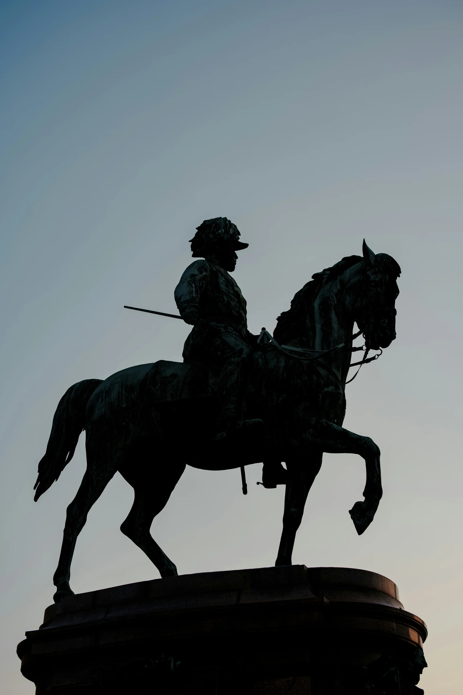 the silhouette of a statue of a soldier on horseback