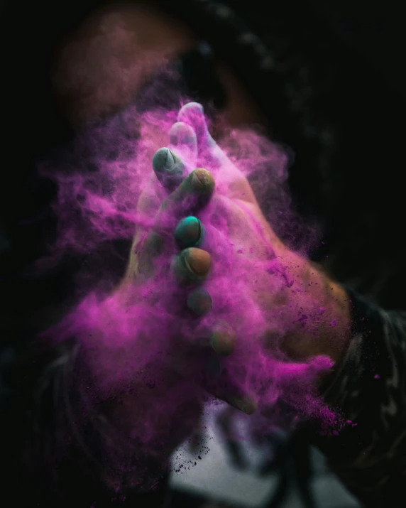 a person has their hands in the smoke