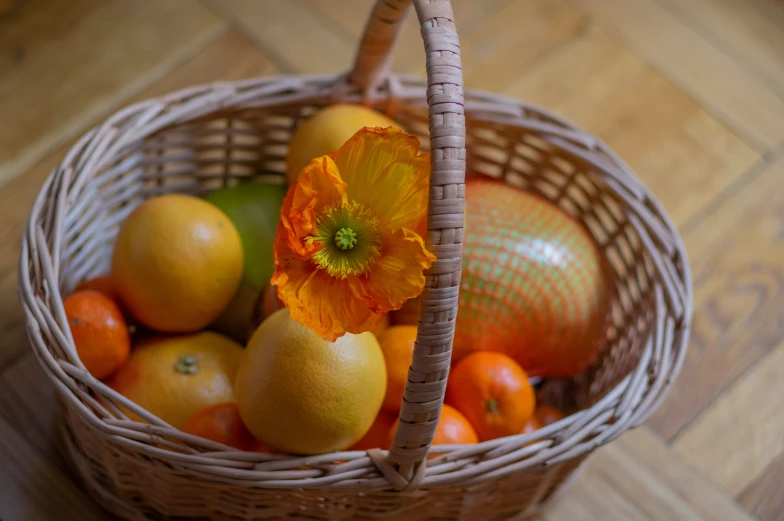 a wicker basket filled with fruits and oranges