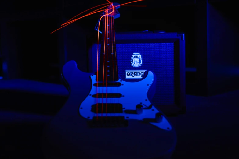 a guitar, amplifier and sound equipment in a dark room