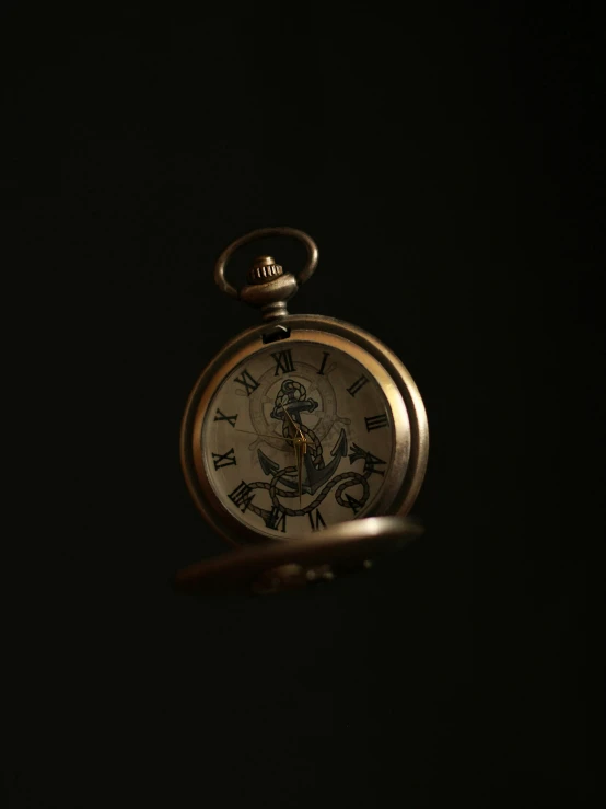 a pocket watch is showing the time in roman numerals