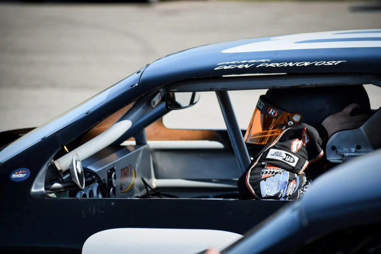 the cockpit and window of a race car at a race