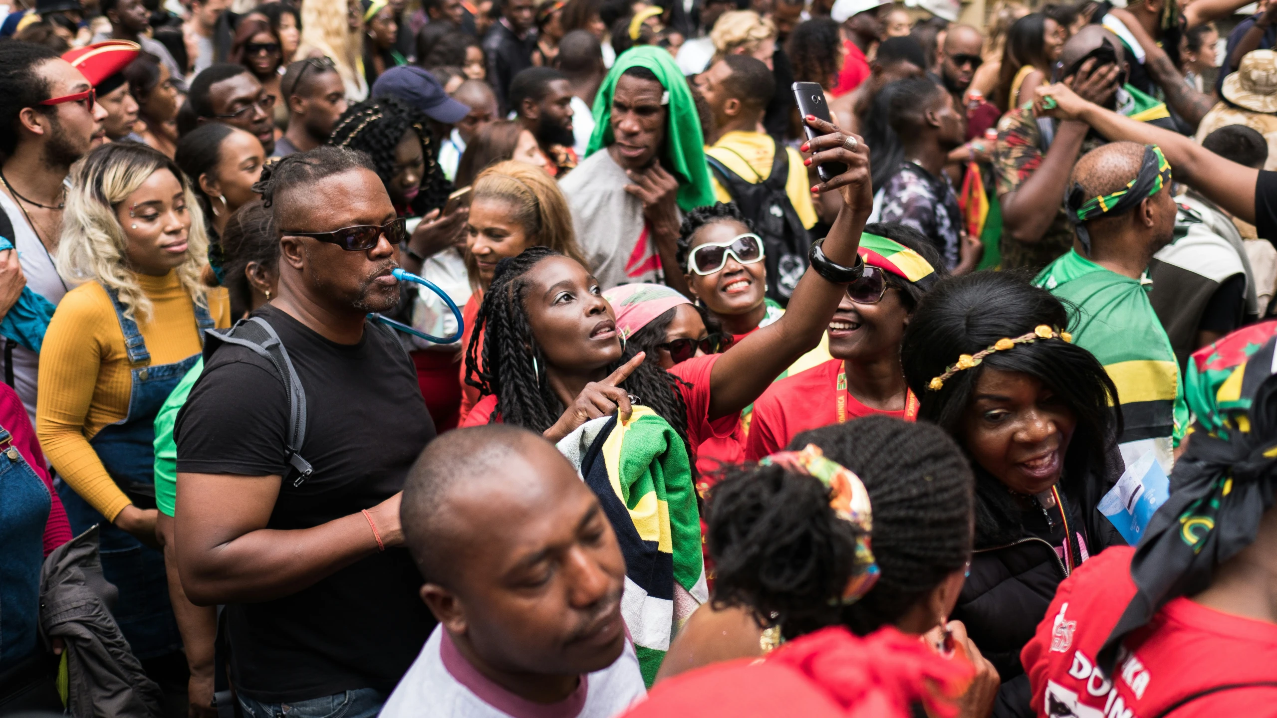 a crowd of people watching an event with two men and a woman