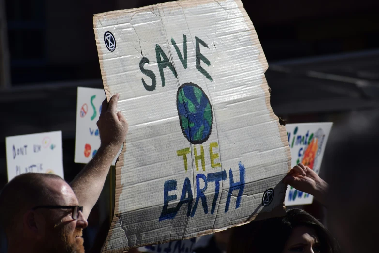 a group of people holding up posters and signs