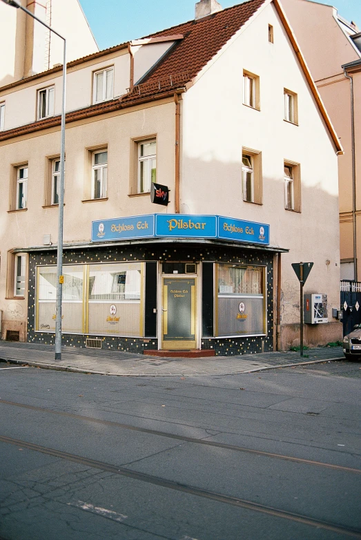 there is an old building with a blue sign on it