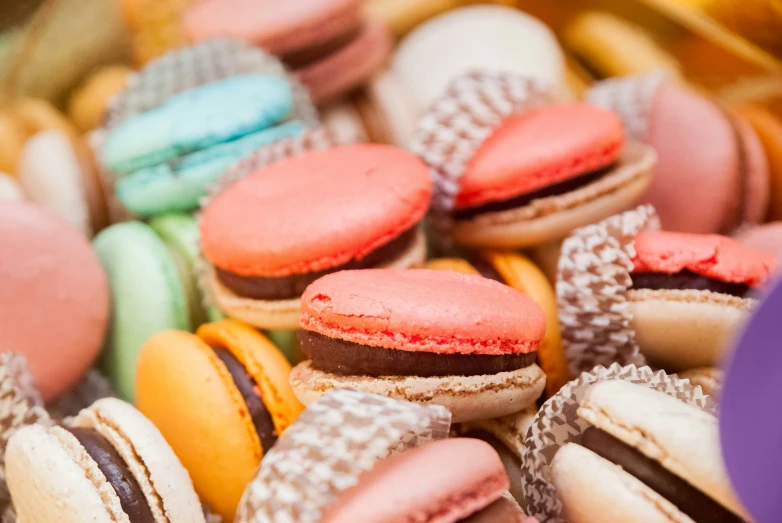 many colorful french macaroons are on display