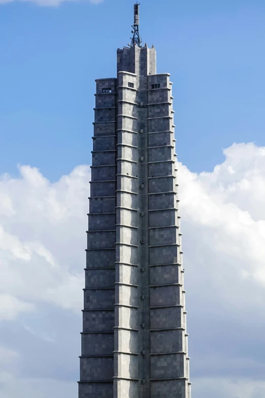 a clock tower has an electronic tower built at the top of it