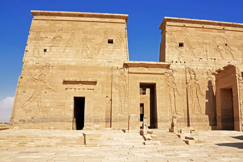 two large brown buildings with very tall doors