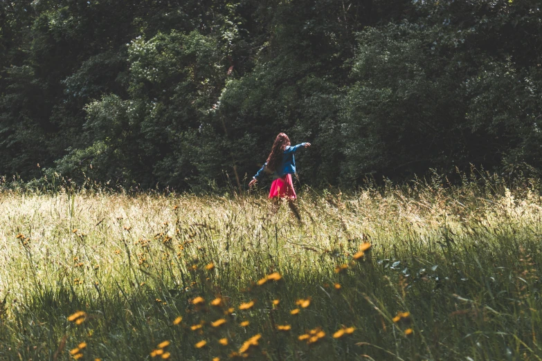 two young s running across the grass in a field