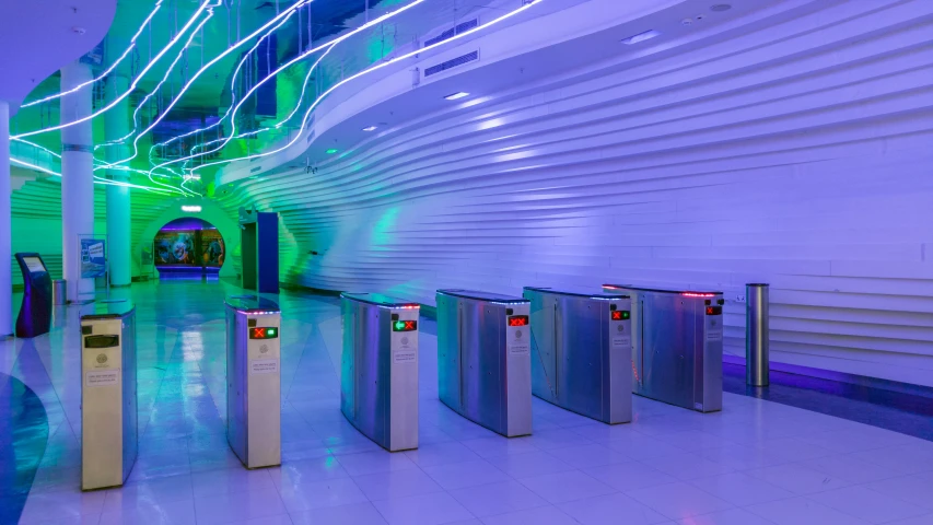 several turns at an airport with green lights on the ceiling