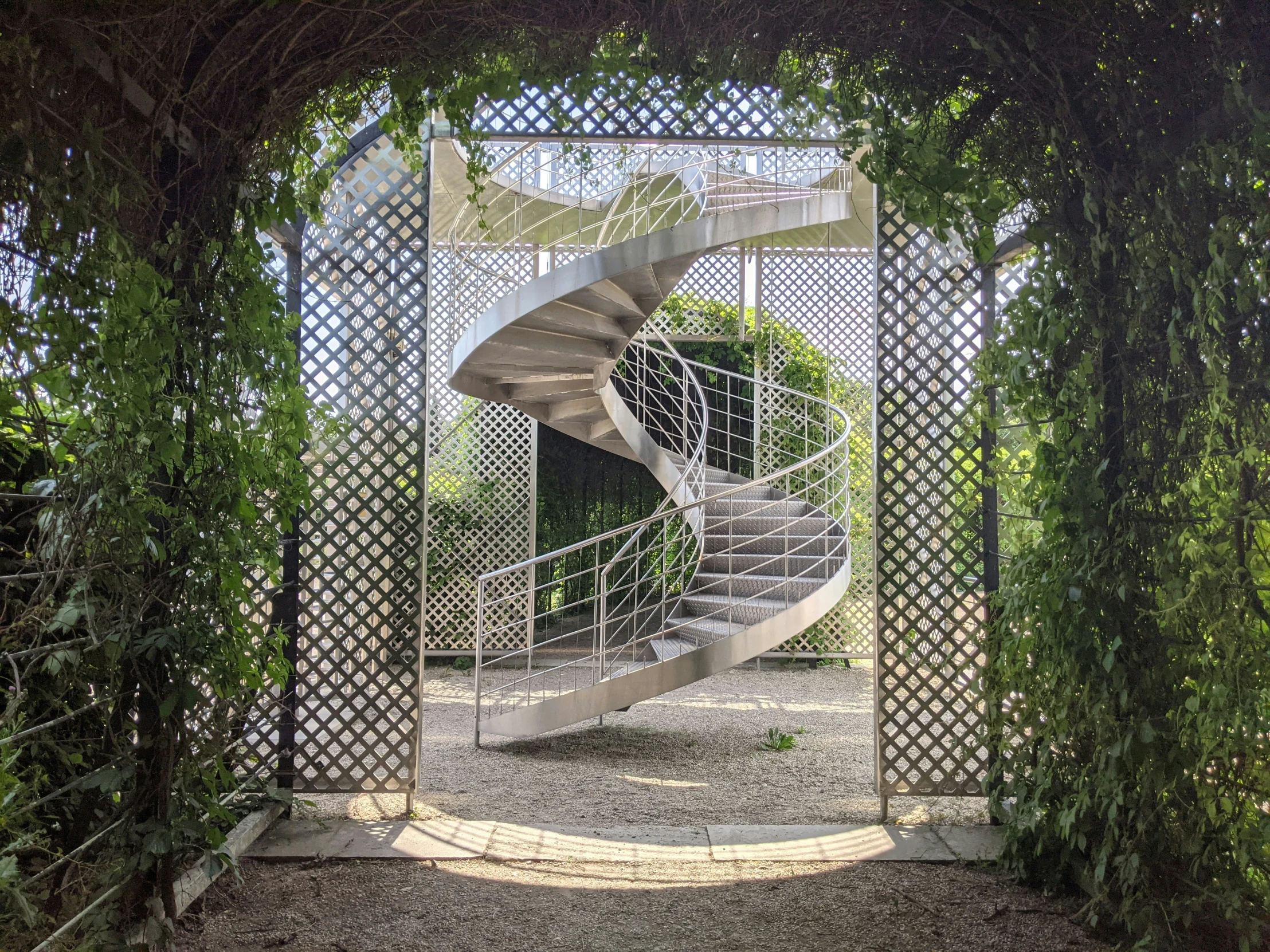 a stair case with a circular design is shown through the trees