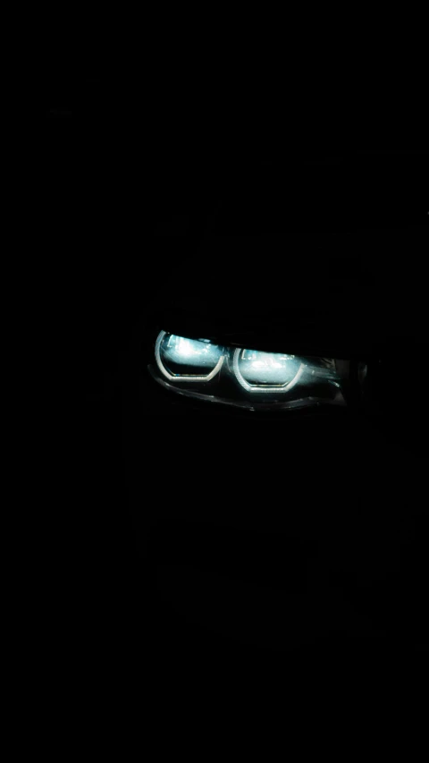 the headlights of a car at night in the dark