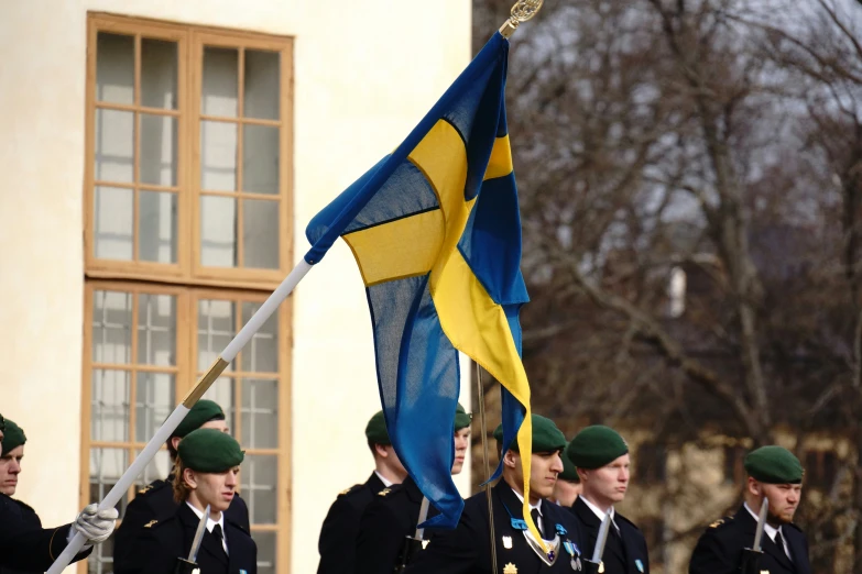 a group of people marching with flags