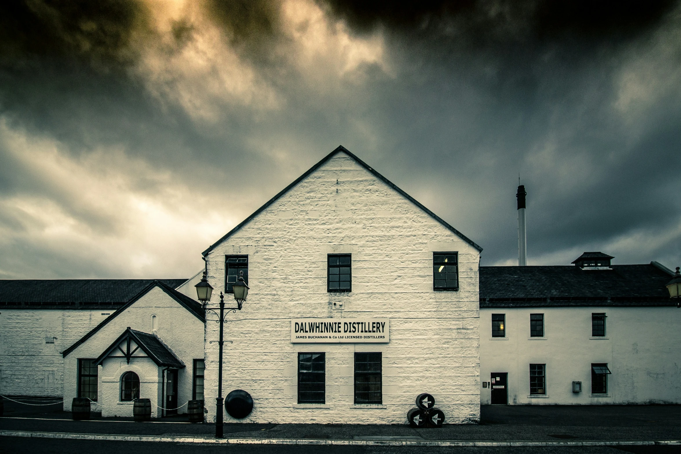 a big white brick building with an interesting roof