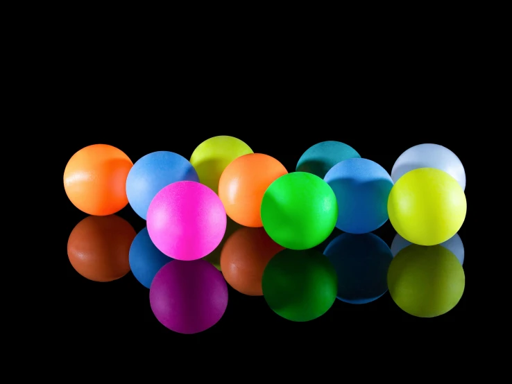 a group of brightly colored balls are arranged in a row