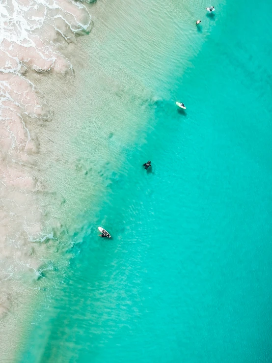 four small boats in the clear blue waters