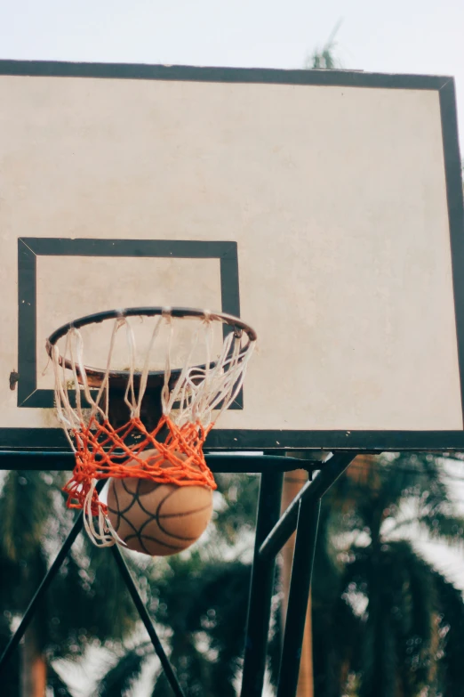 a basketball flies through the net