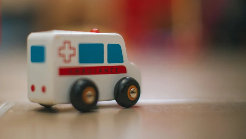 a toy ambulance sitting on the floor