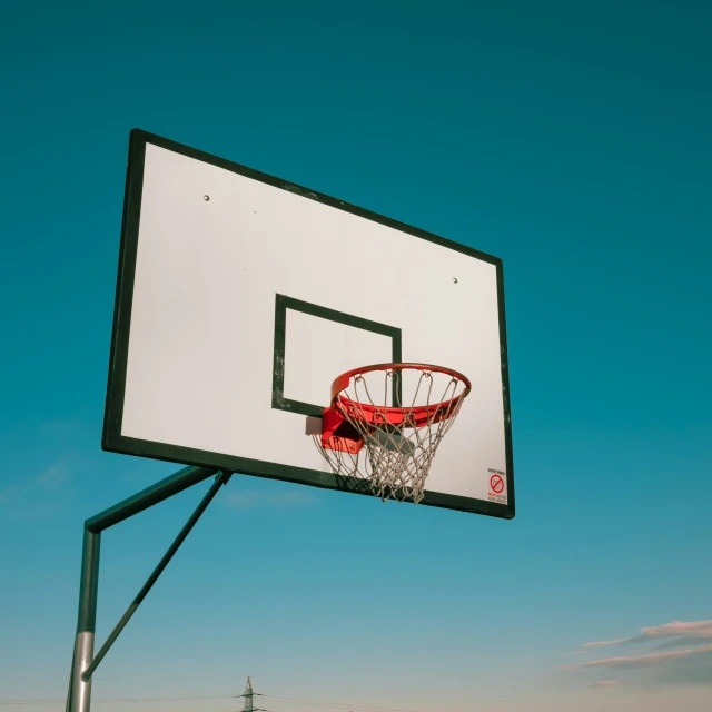 basketball going through the net with the sky in the background