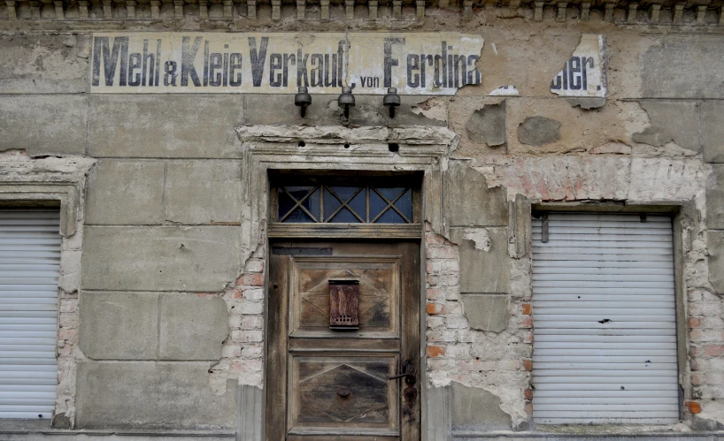 a broken down door and window on an old building