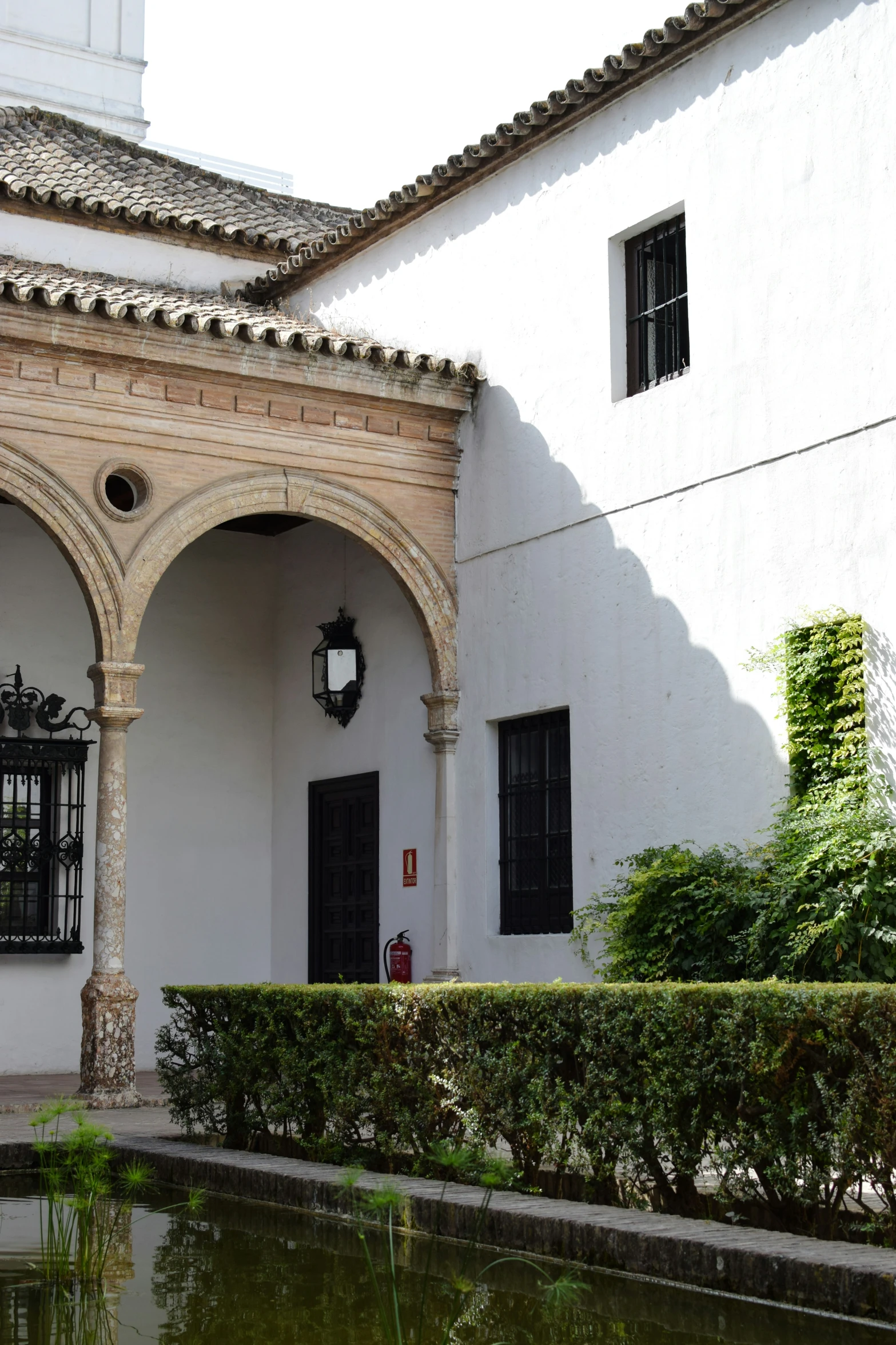 a building with arched windows and an fountain