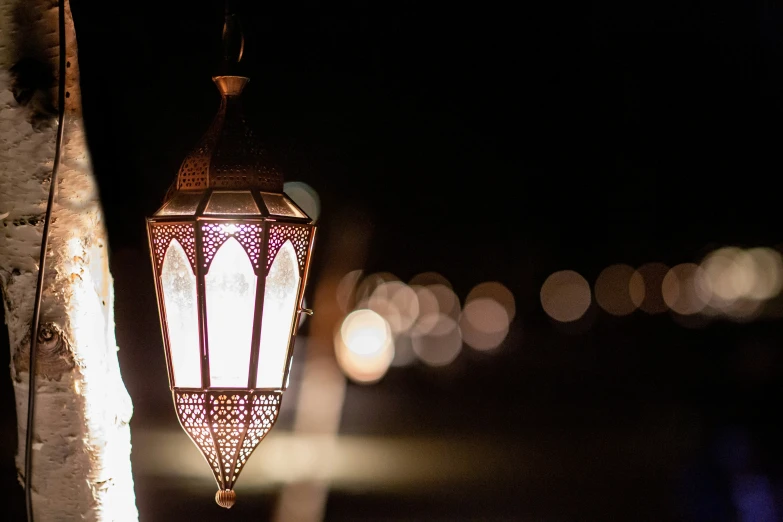 an old fashioned streetlight hanging on the side of a building