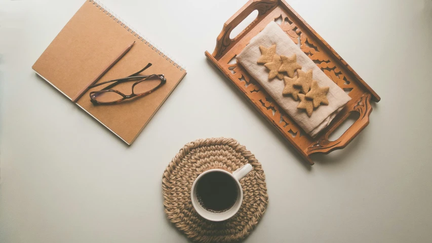 a place setting with a box, pen and eyeglasses