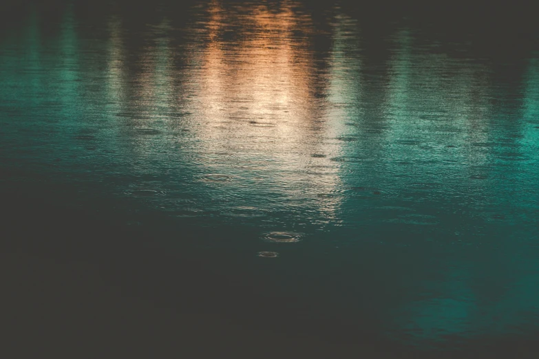 water reflection at night with bright lights in the background