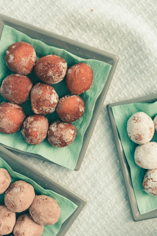 there are three different kinds of donuts on top of green dishes