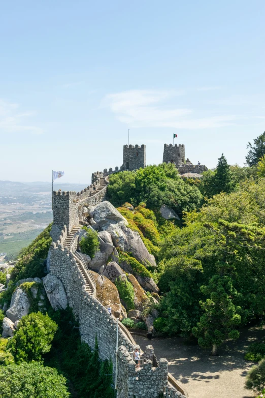 a castle is perched on top of a mountain