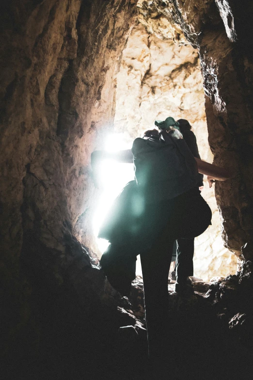 some people are standing in a tunnel and looking for soing