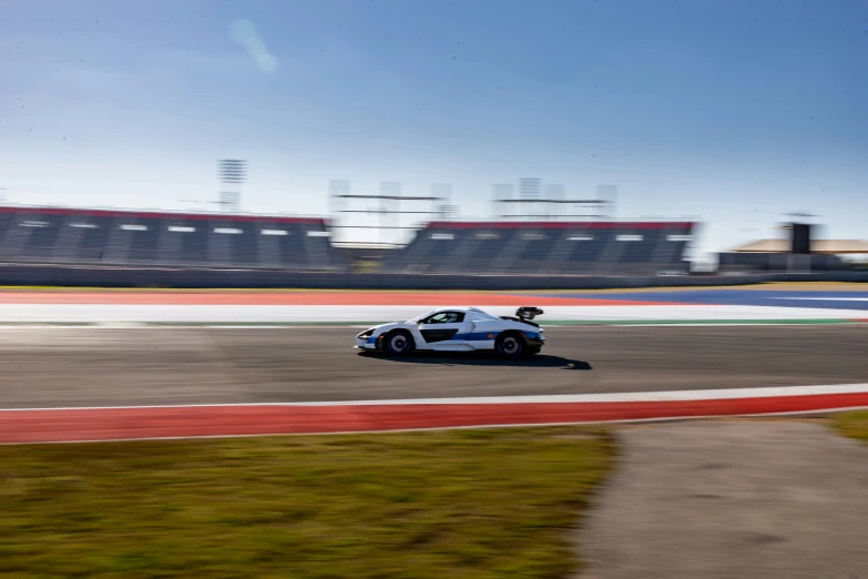 an image of a sport car racing around a track