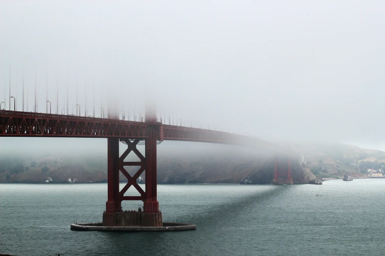 the golden gate bridge is pictured on a foggy day