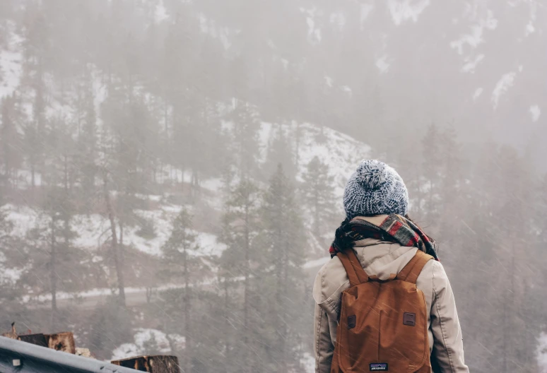 person walking on a balcony in the snow