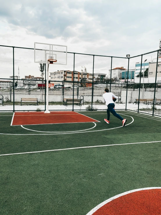 two children are practicing in the fenced in area