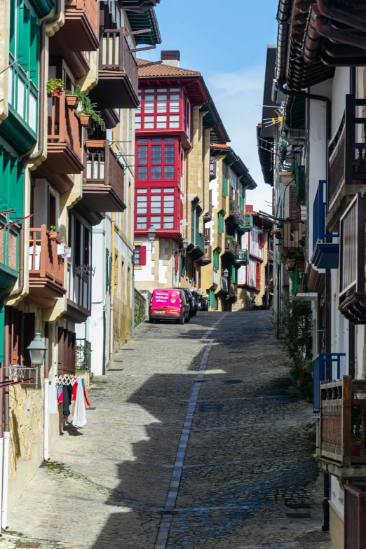 a red car parked next to an older style building