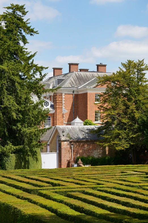 a house with trees and grass on the side of it