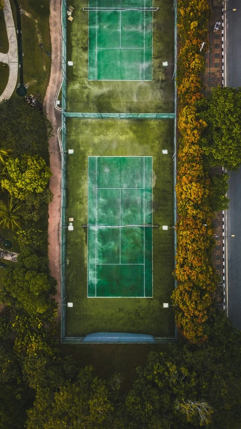a bird's eye view of an aerial view of two tennis courts